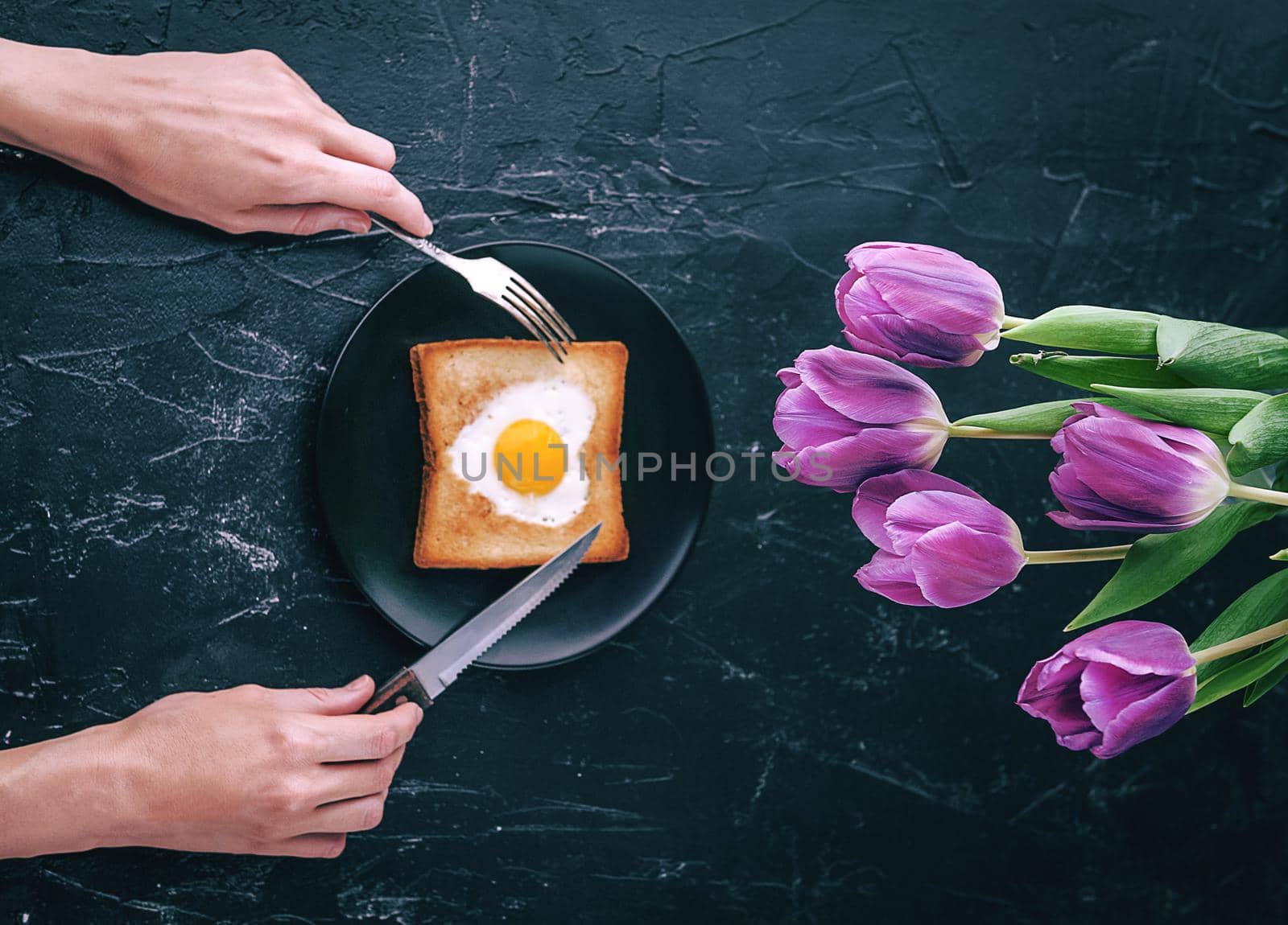 Still breakfast for a loved one with tulips on a dark background