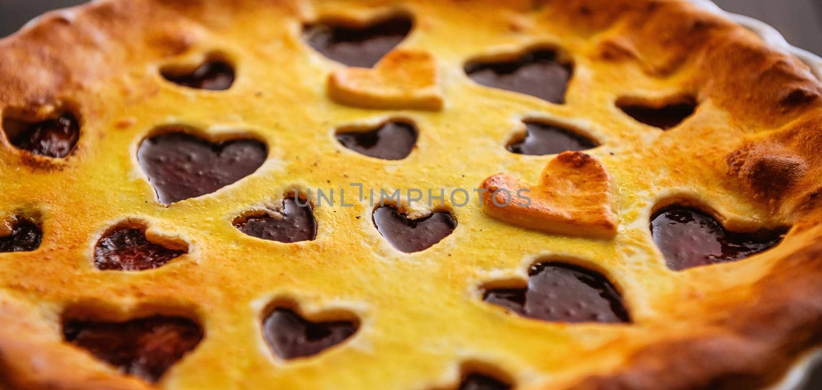 strawberry cake for Valentine's Day with hearts on a wooden background