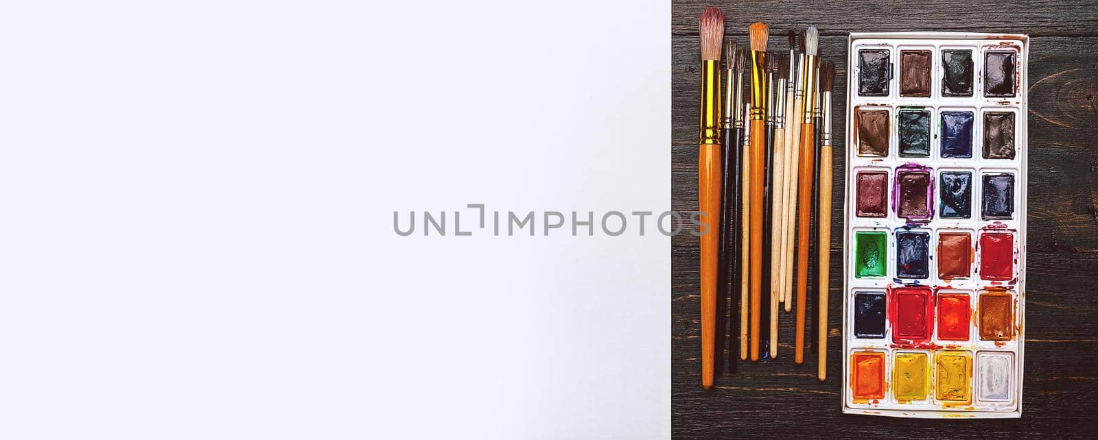 artistic brushes on wooden background by vvmich