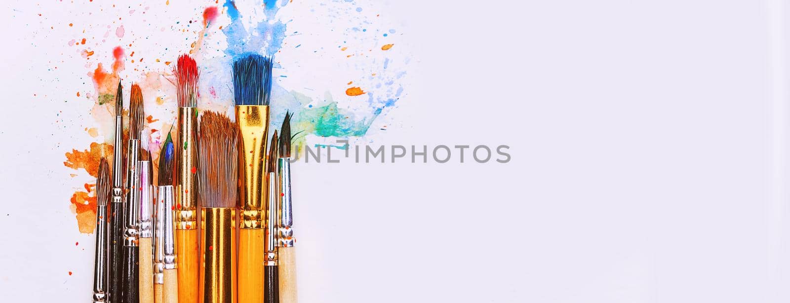 artistic brushes on wooden background