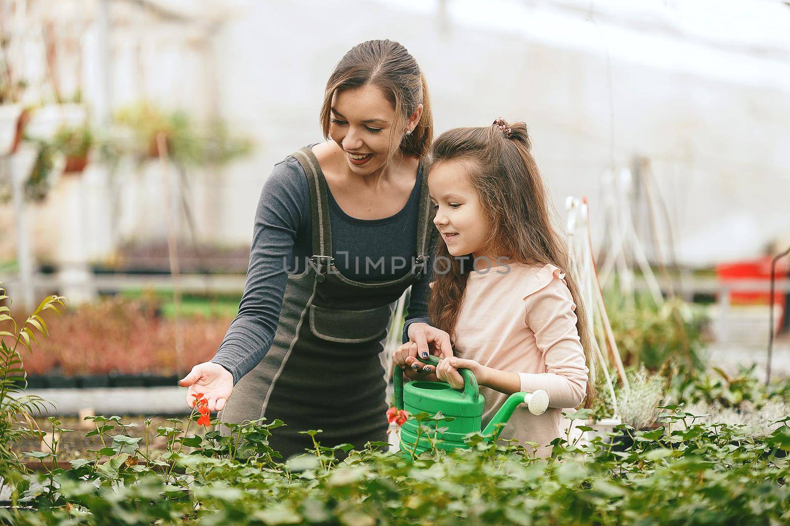 mother and daughter taking care of plants