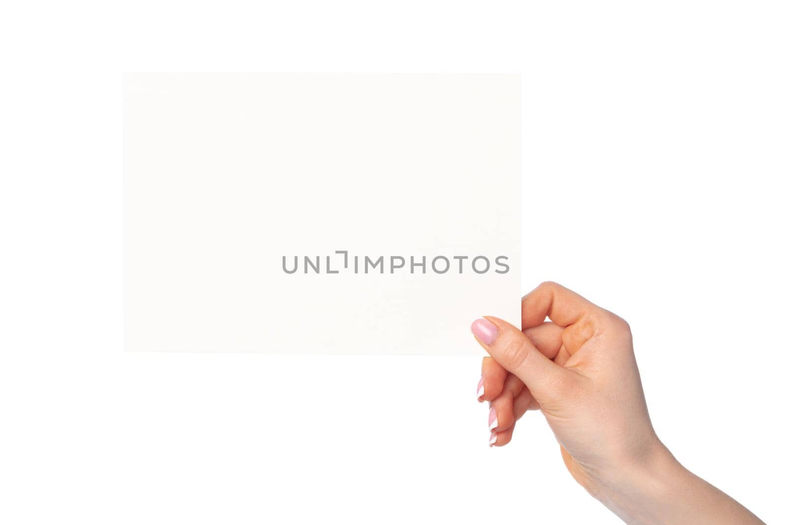 Woman's hand holding blank white sheet of paper isolated on white background