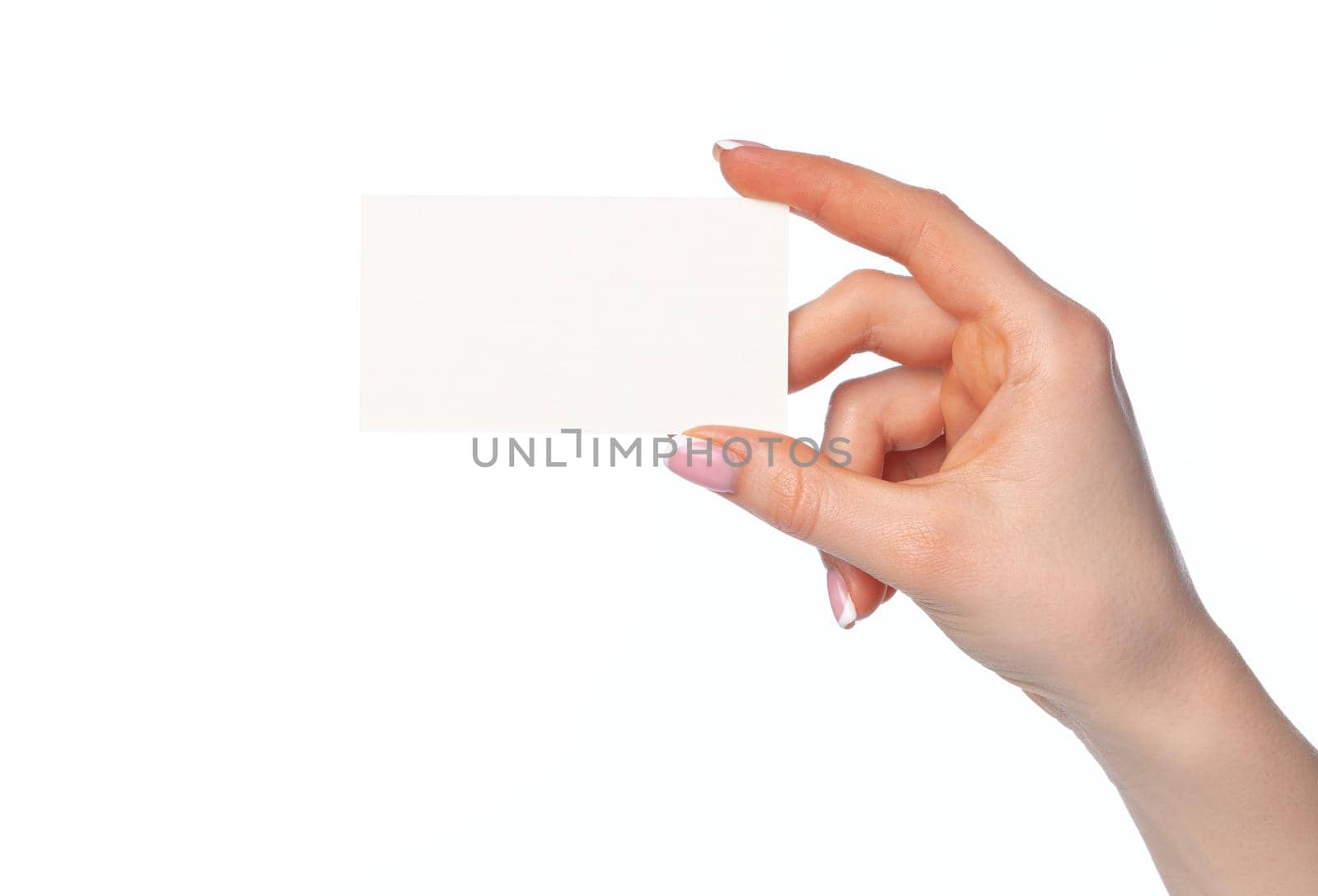 Beautiful female hand holding white business card isolated on white background