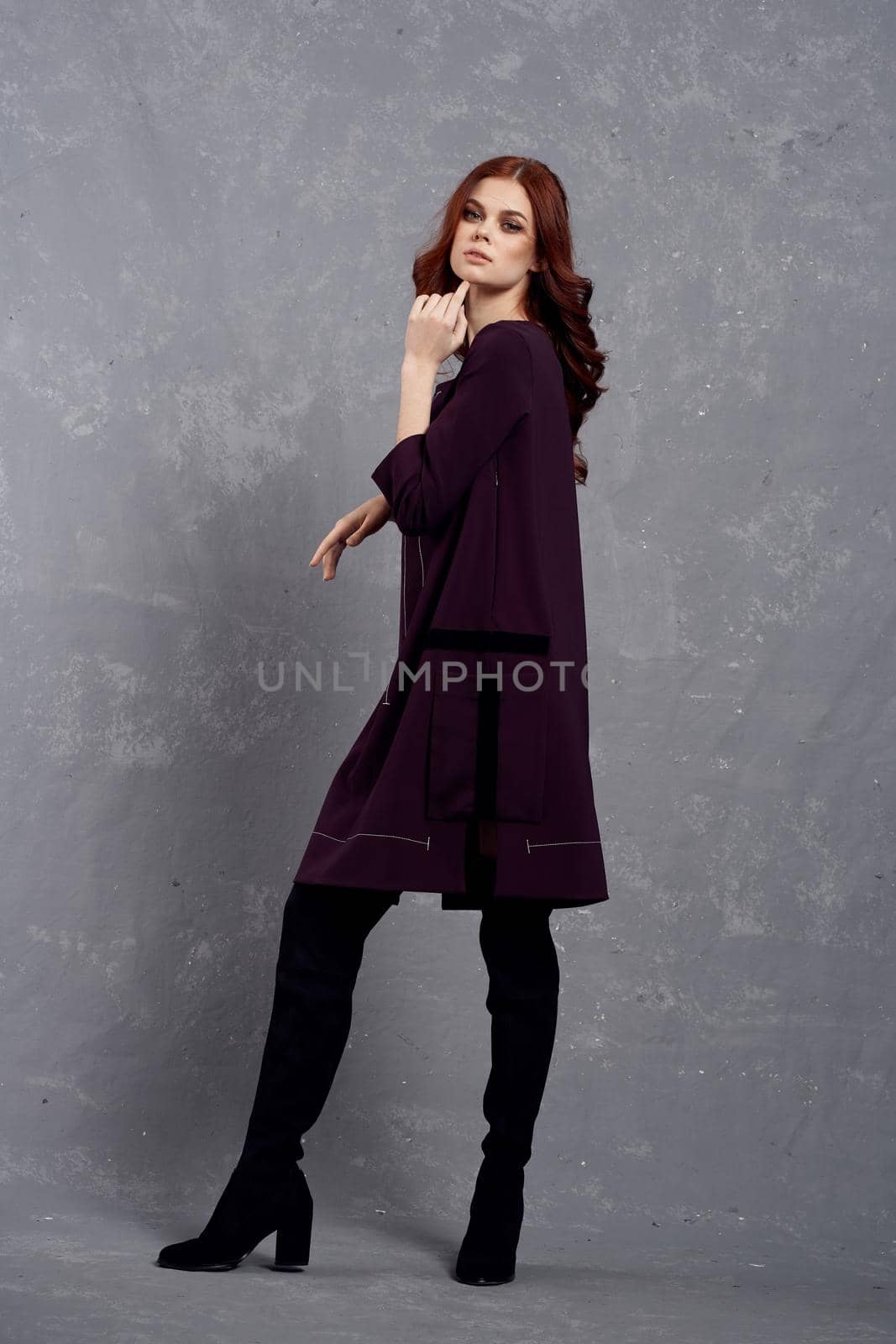 woman with red hair posing fashionable clothing elegant style. High quality photo