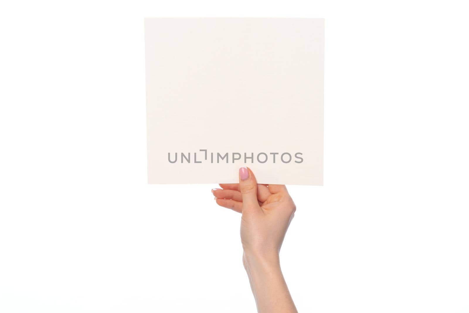 Woman's hand showing white paper banner isolated on white background