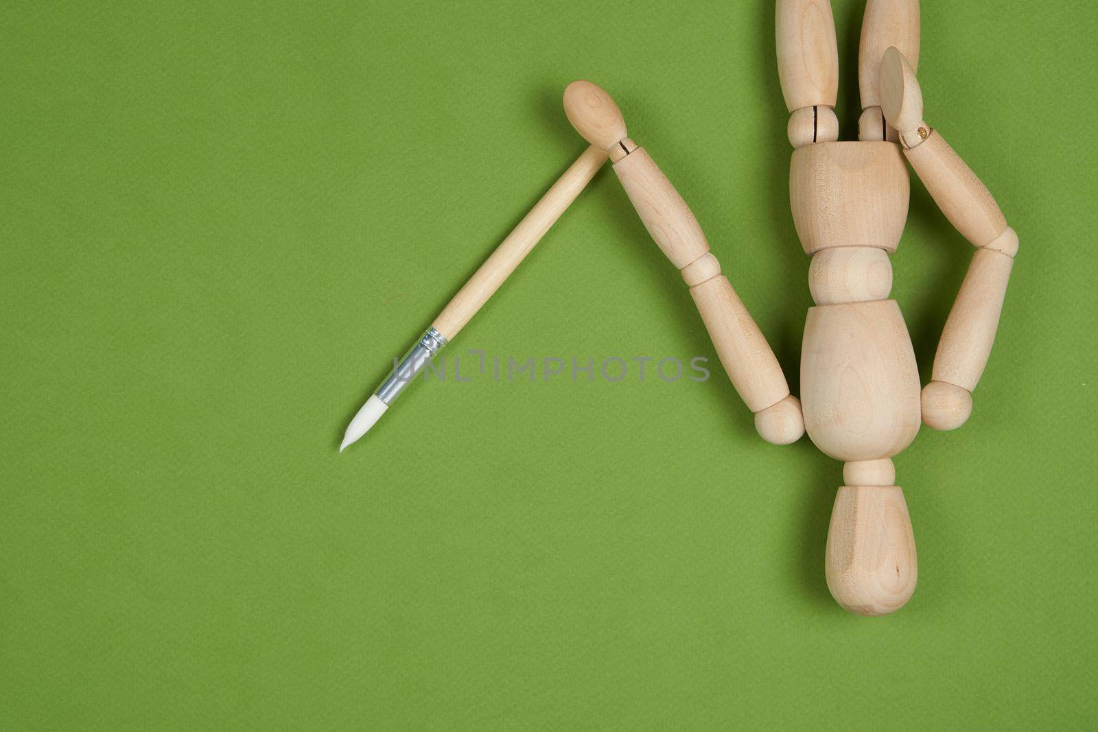 wooden mockup for painting brush green background. High quality photo