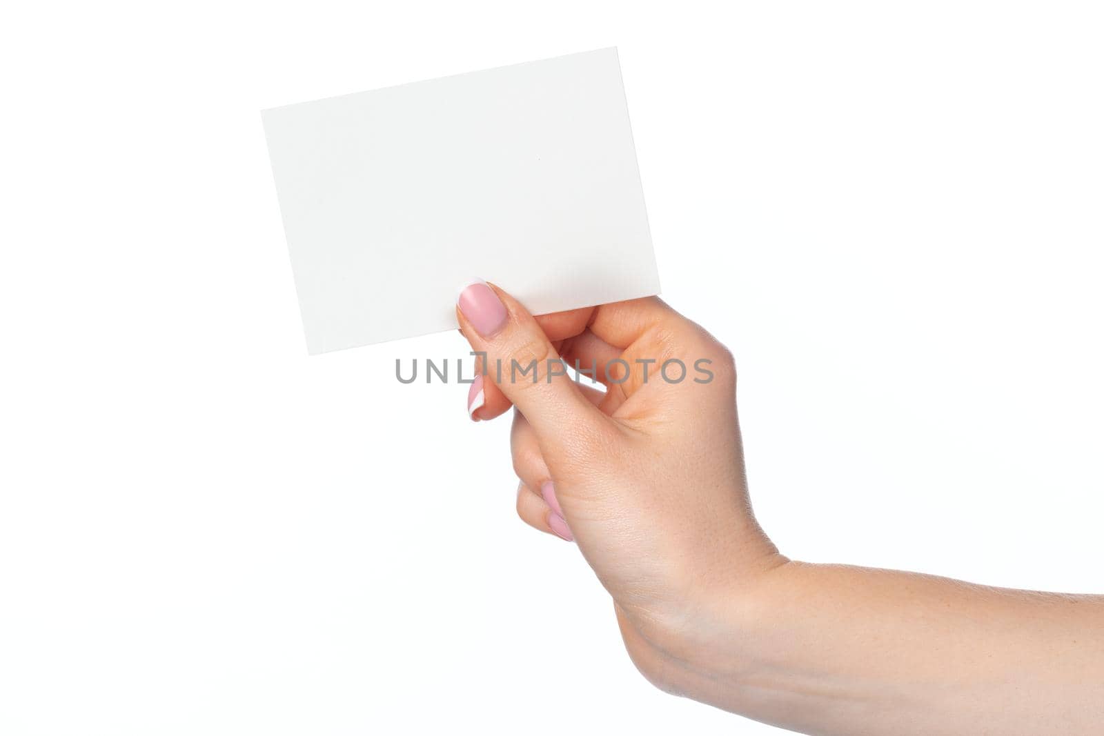 Woman's hand with blank white business card isolated on white background