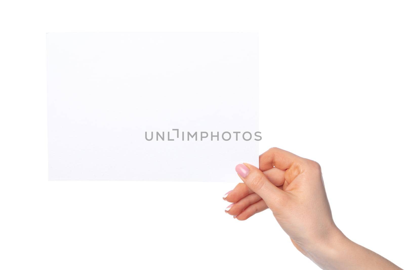 Woman's hand holding blank white sheet of paper isolated on white background