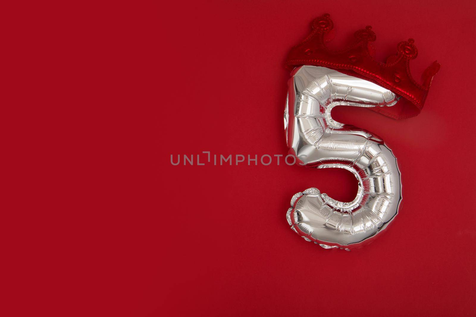 Silver Number Balloons 5 five in crown on dark red background. Holiday Party Decoration, 5 postcard concept with top view