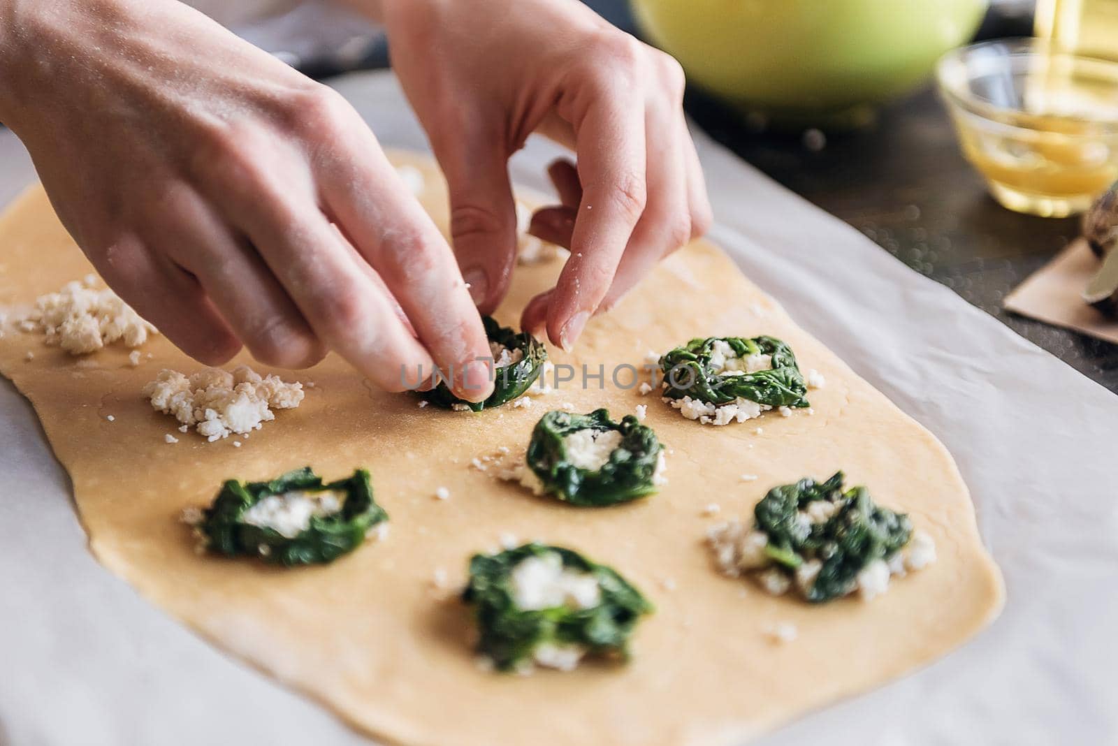 Step by step the chef prepares ravioli with ricotta cheese, yolks quail eggs and spinach with spices. The chef prepares the filling on the dough