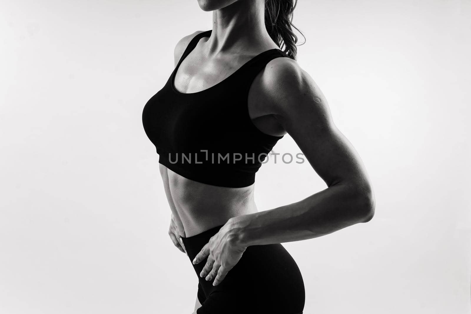 Seductive young redhead woman in bikini isolated on black, white background