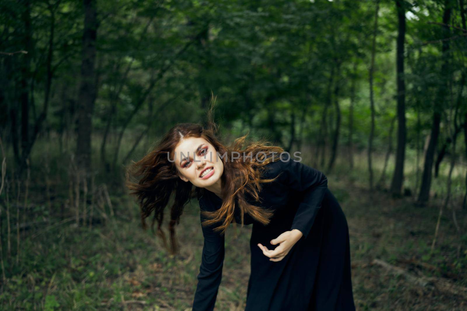 cheerful woman witch in the forest posing fantasy. High quality photo