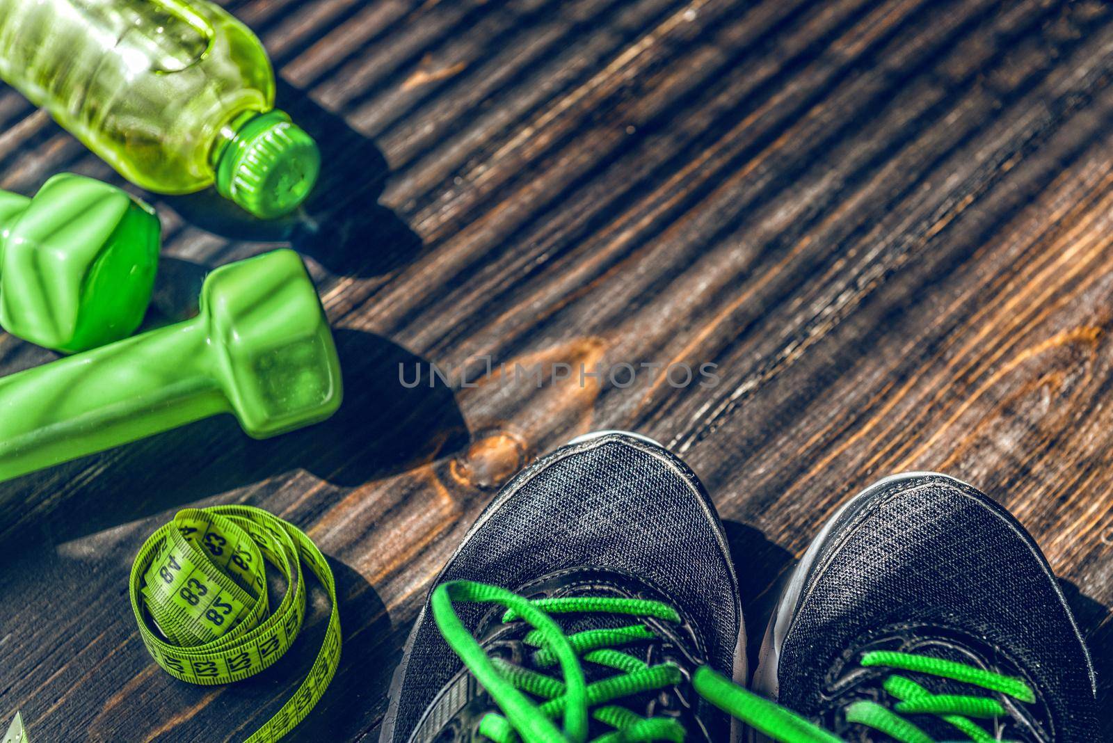 Sneakers dumbbells and a bottle of water. Flat view. All in one color.