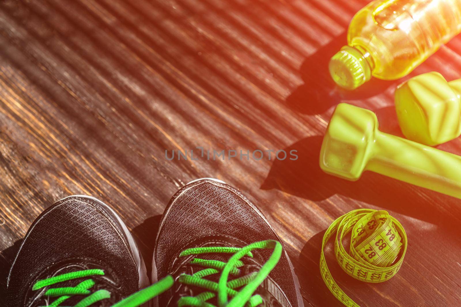 Sneakers dumbbells and a bottle of water. Flat view. All in one color.