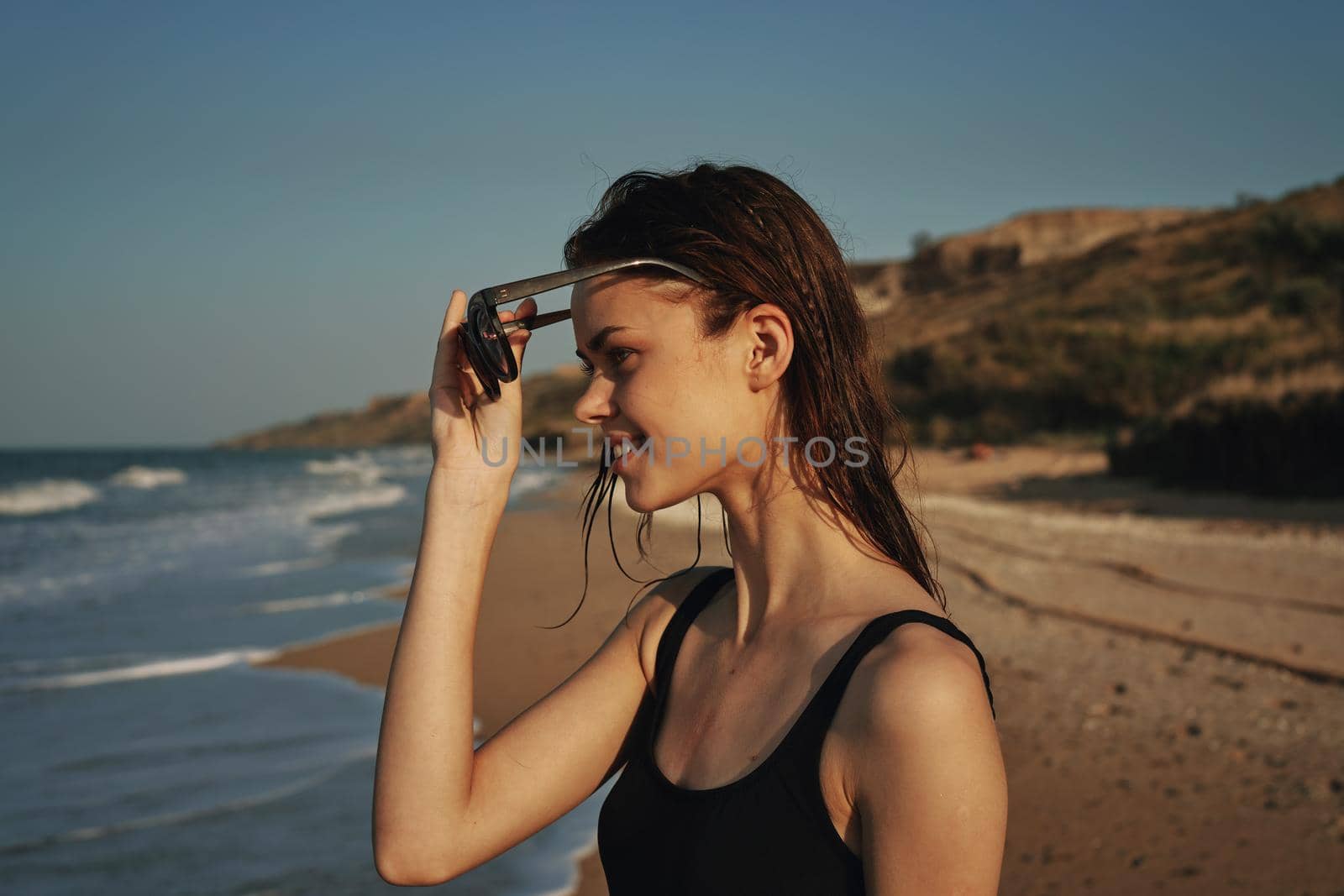 pretty woman in black swimsuit beach nature sun. High quality photo
