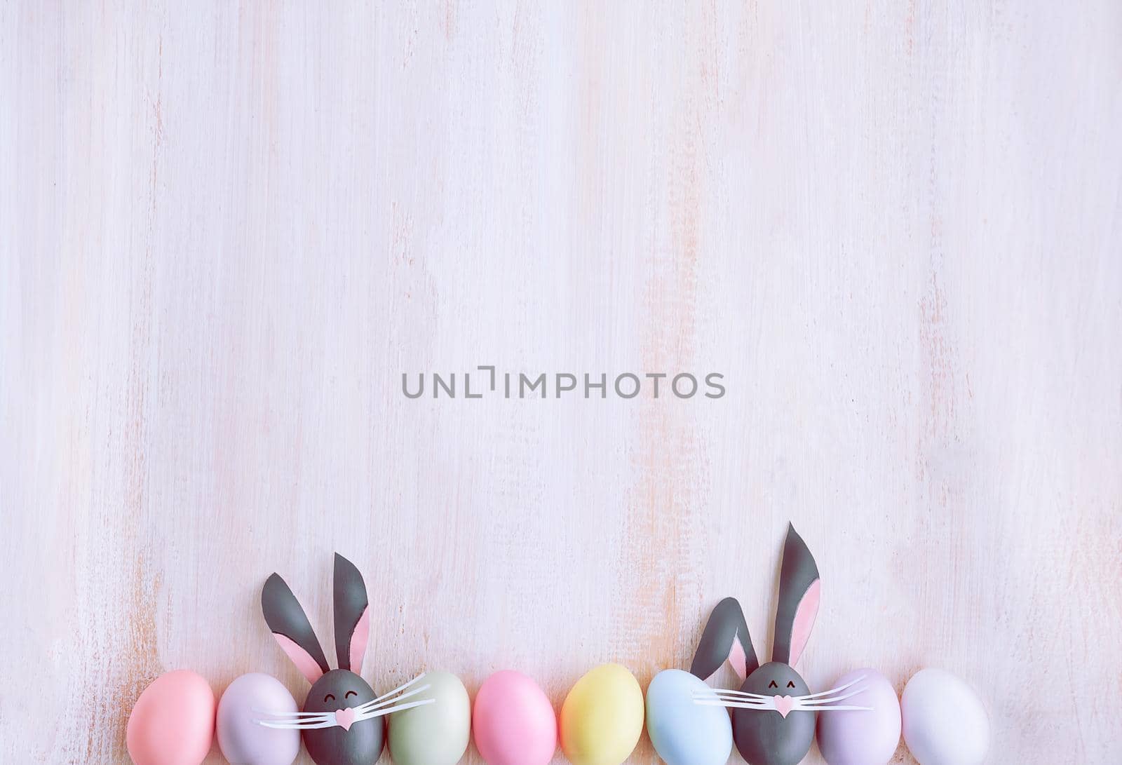 Cute creative photo with easter eggs, some eggs as the Easter Bunny