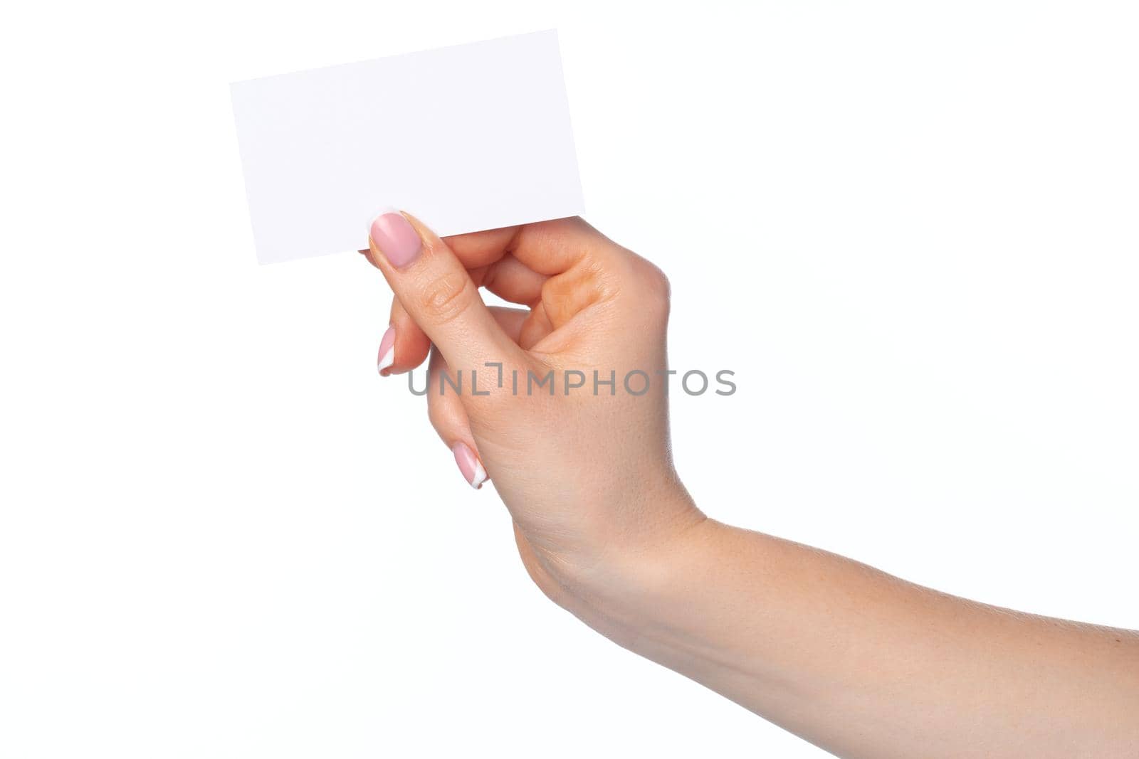 Beautiful female hand holding white business card isolated on white background