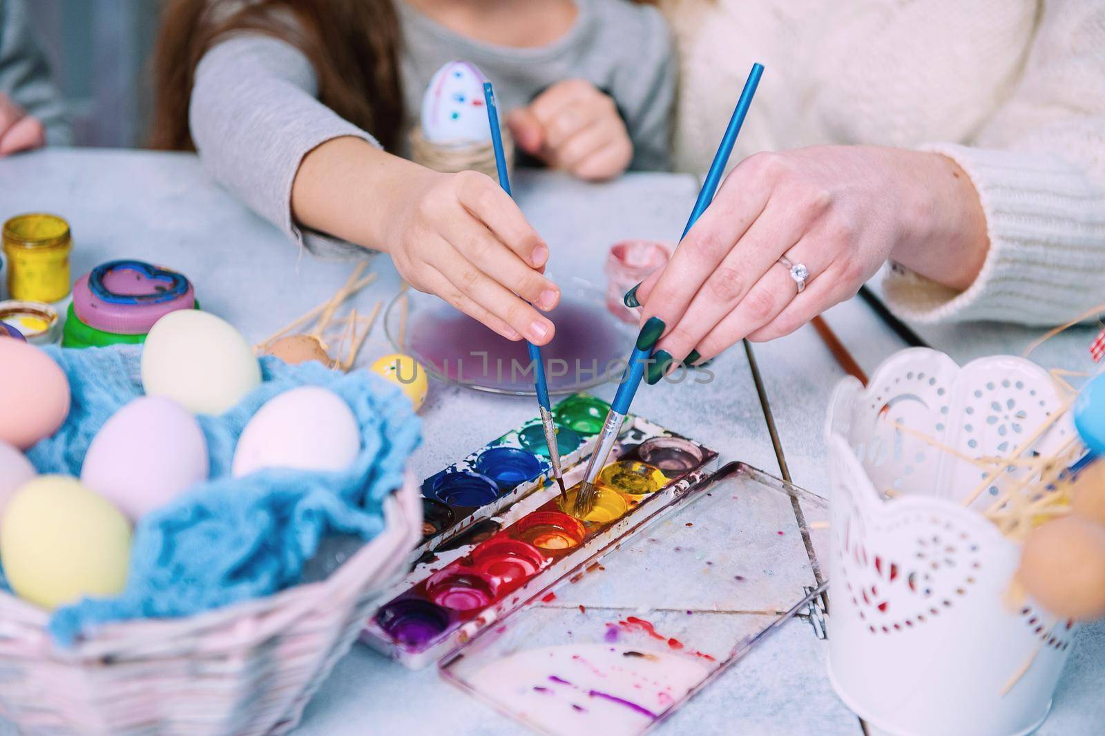 little girl paints an Easter egg by vvmich