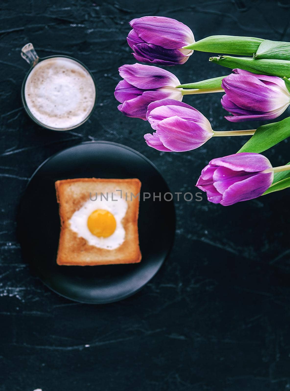 Still breakfast for a loved one with tulips on a dark background