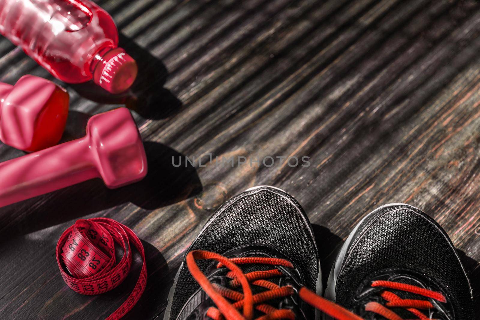 Sneakers dumbbells and a bottle of water. Flat view. All in one color.