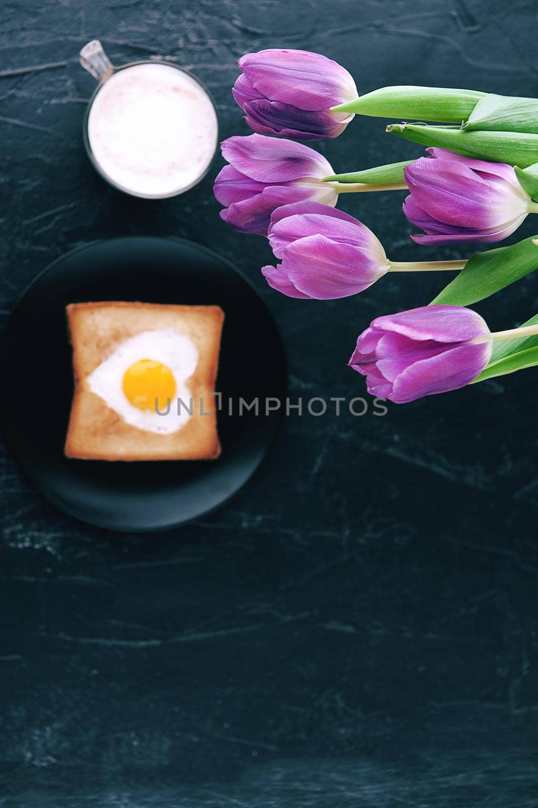 Still breakfast for a loved one with tulips on a dark background by vvmich