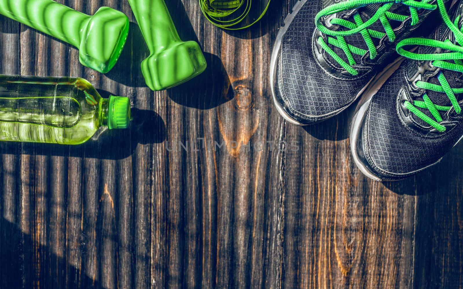 Sneakers dumbbells and a bottle of water. Flat view. All in one color.