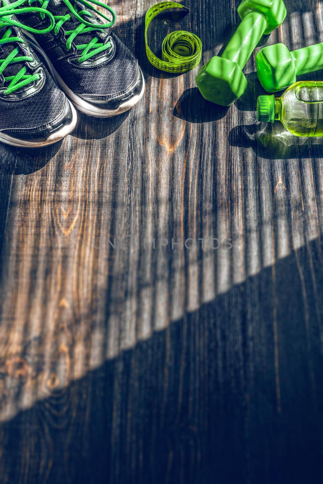 Sneakers dumbbells and a bottle of water. Flat view. All in one color.