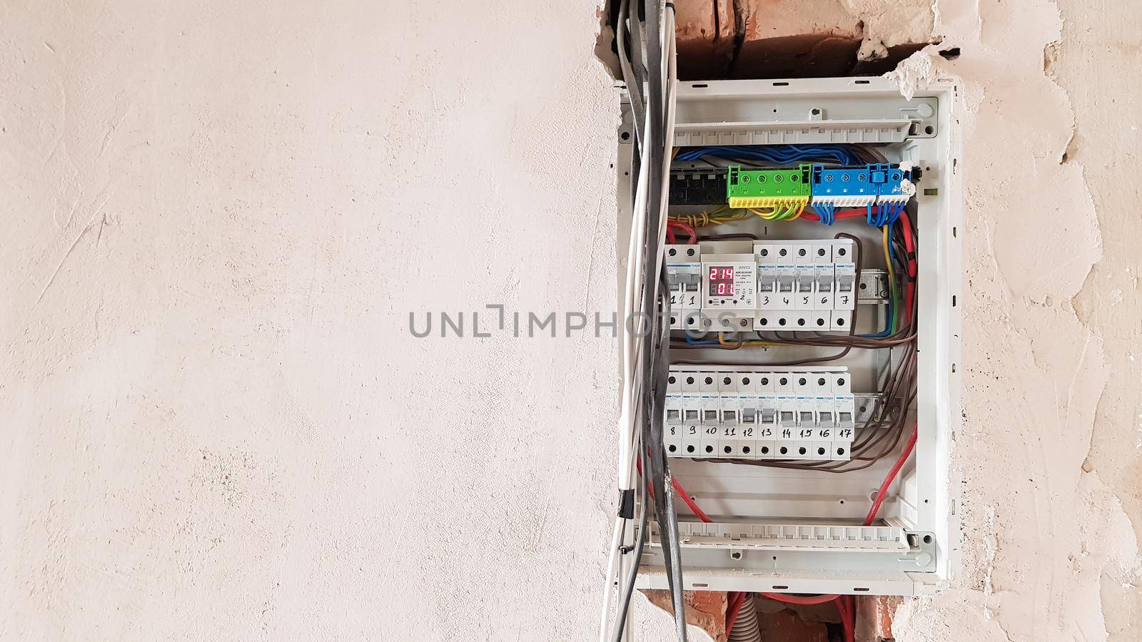 Electrical safety in homes, switchboard panel with switches. Home electrical system in the apartment under repair. Circuit breakers with wires in an electric screen with copy space