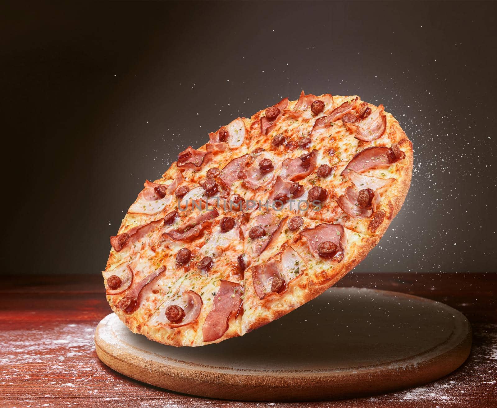 classic pizza on a dark wooden table background and a scattering of flour. pizza restaurant menu concept