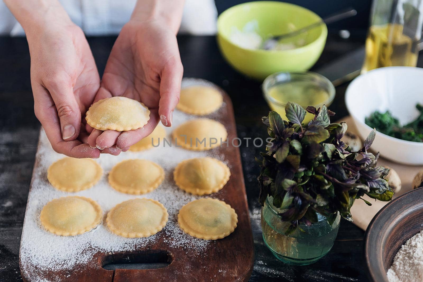 Step by step the chef prepares ravioli with ricotta cheese, yolks quail eggs and spinach with spices. The chef prepares to cook ravioli by vvmich