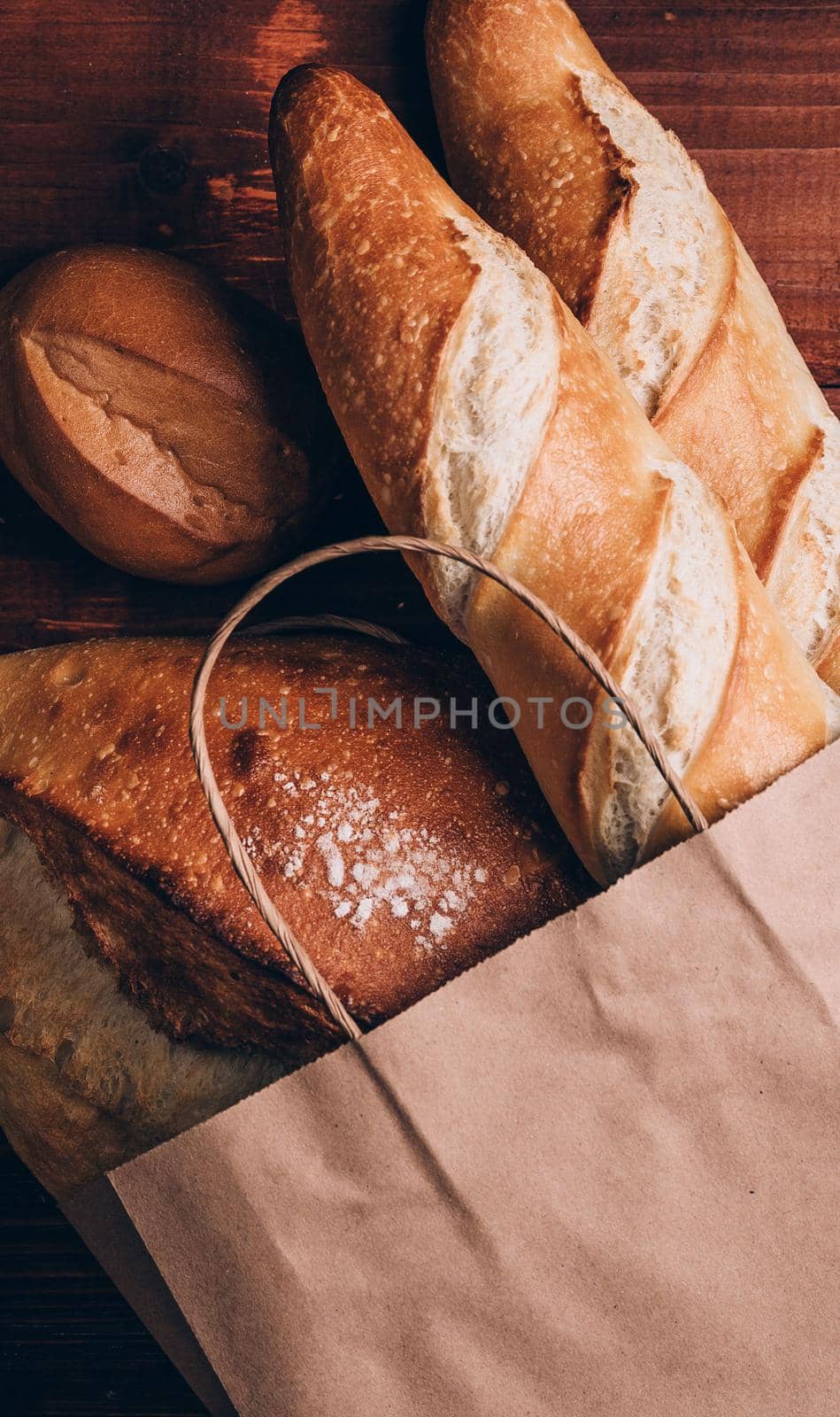 fresh bread in a paper bag. small bakery concept with gluten free flavored bread by vvmich