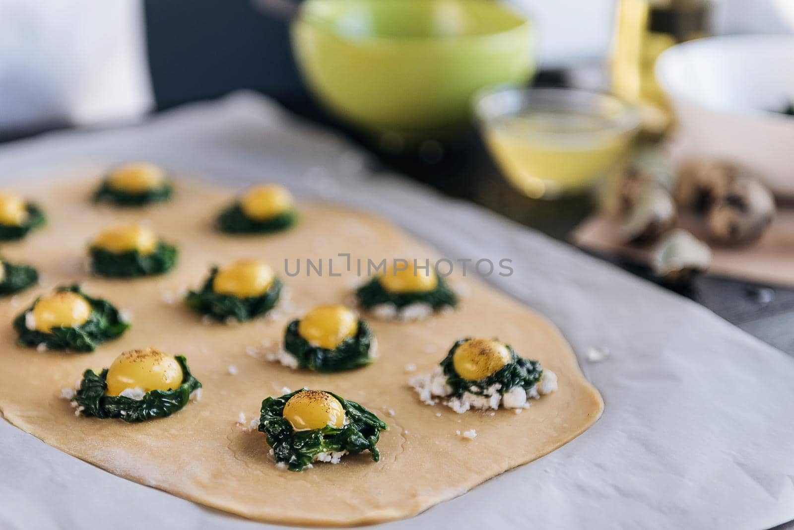 Step by step the chef prepares ravioli with ricotta cheese, yolks quail eggs and spinach with spices. The chef prepares the filling on the dough by vvmich