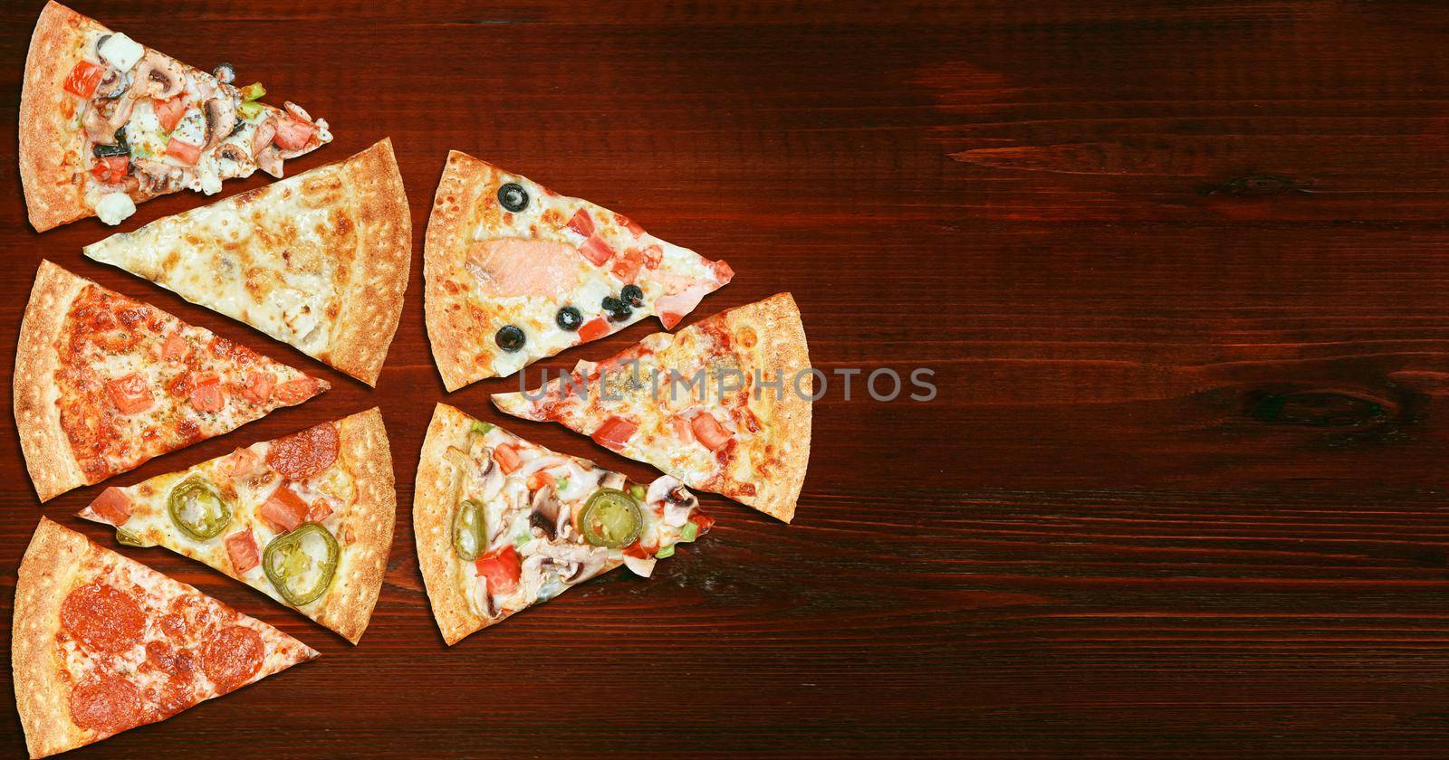 mix of eight different pizzas on a wooden background. menu concept of choice and diversity