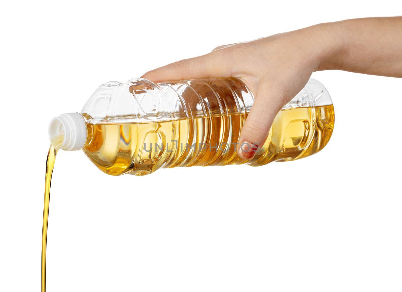 Hand of woman pouring cooking oil from plastic bottle. Isolated on white background. Close up.