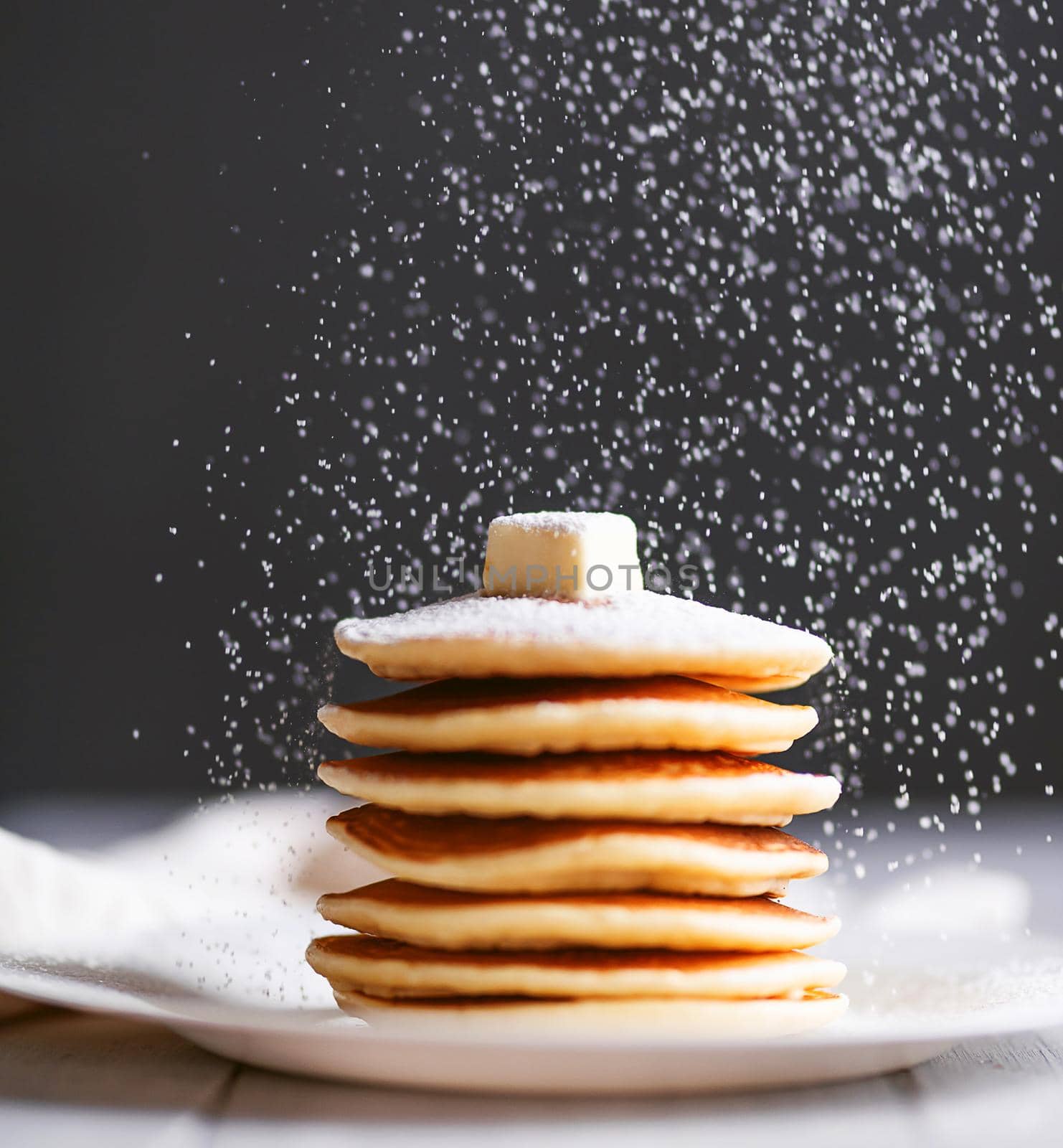 fresh classic pancake stacked in stack on gray background with place for text by vvmich