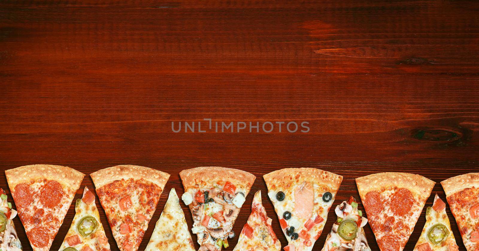 mix of eight different pizzas on a wooden background. menu concept of choice and diversity