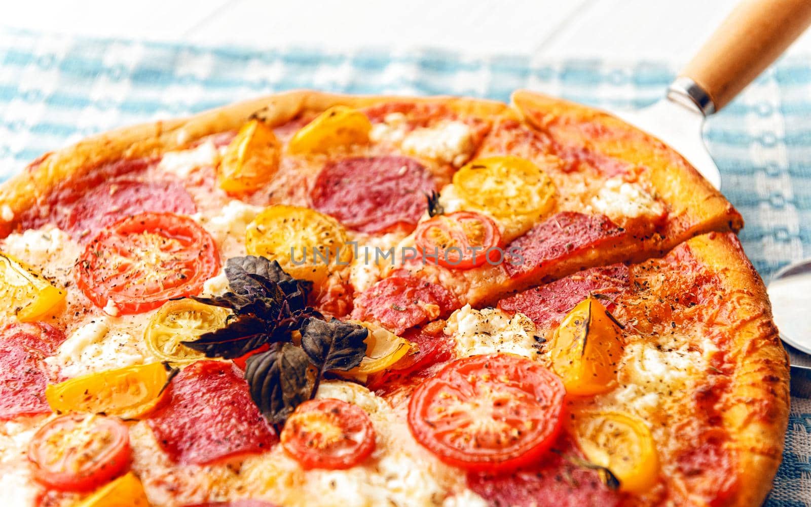 pepperoni italian pizza with salami and cheese on rustic wooden white background