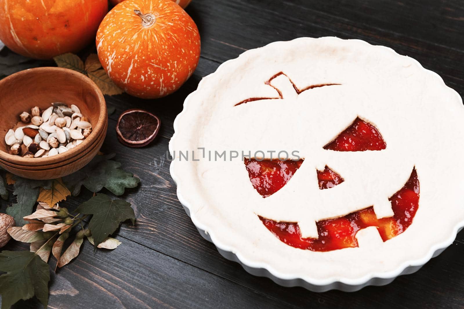 Chef cooks a pie for Halloween with a filling of pumpkin-strawberry jam and peaches