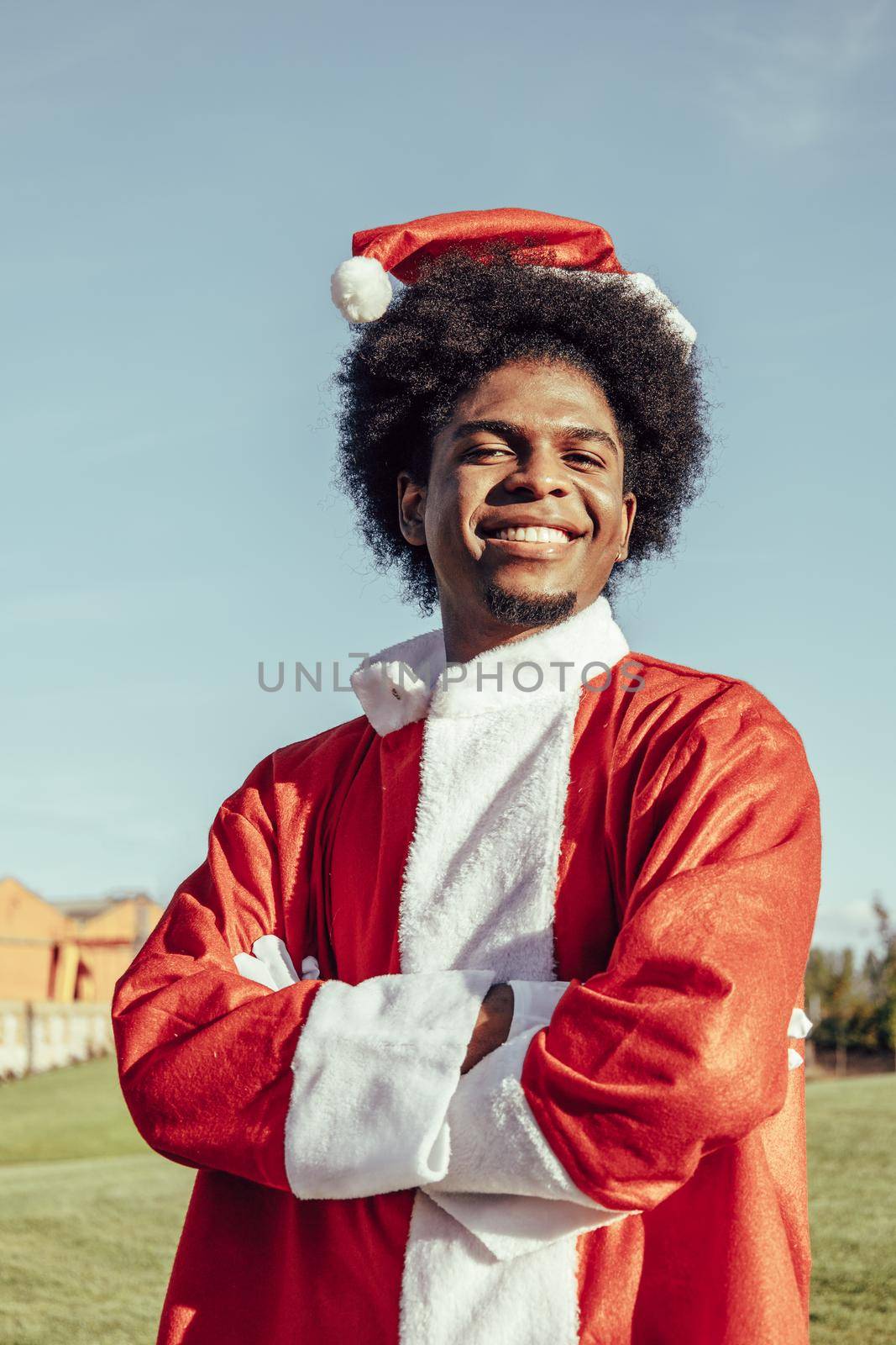 vertical portrait of colombian santa claus with afro hair outdoors