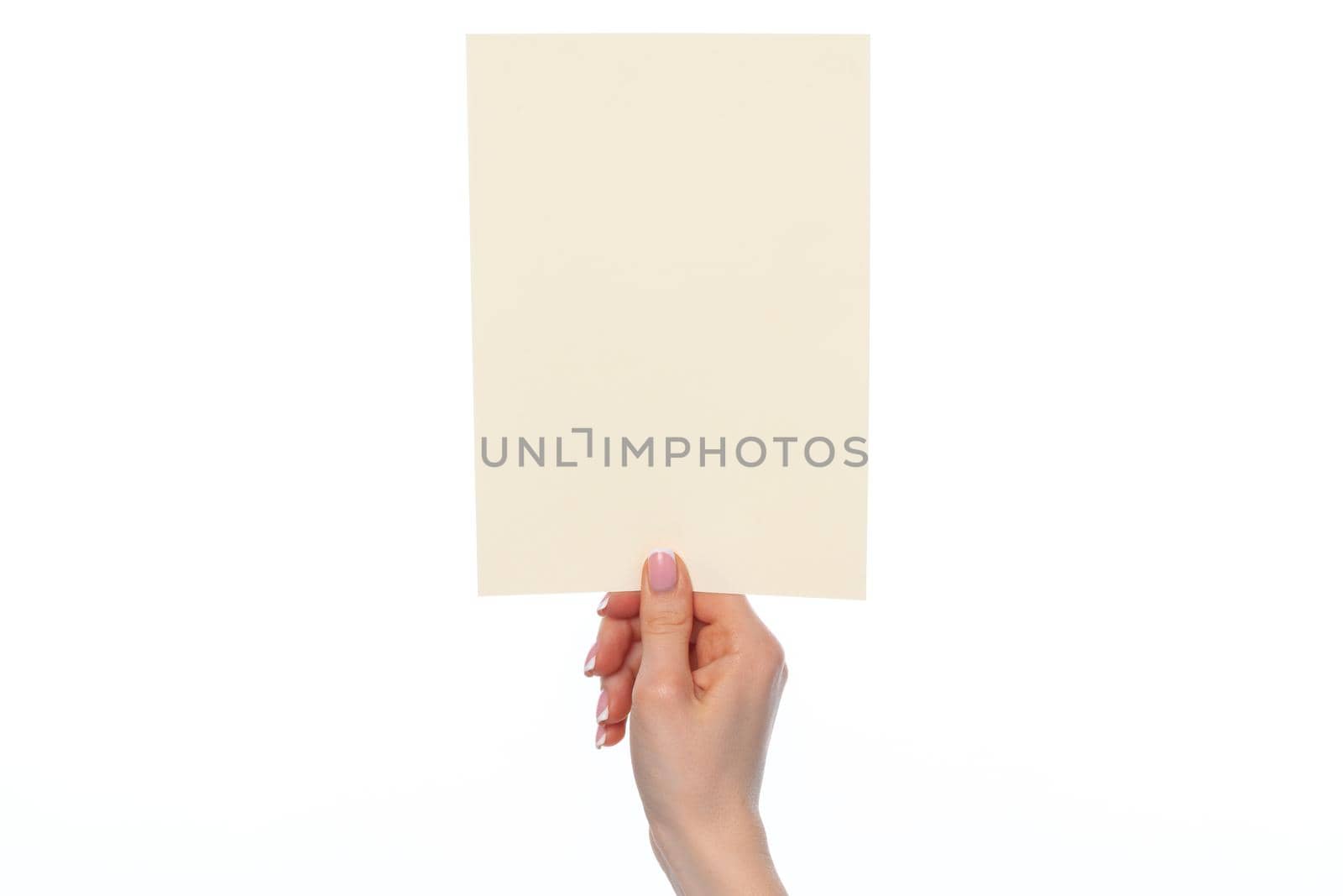 Female hand holding blank white sheet of paper isolated on white background