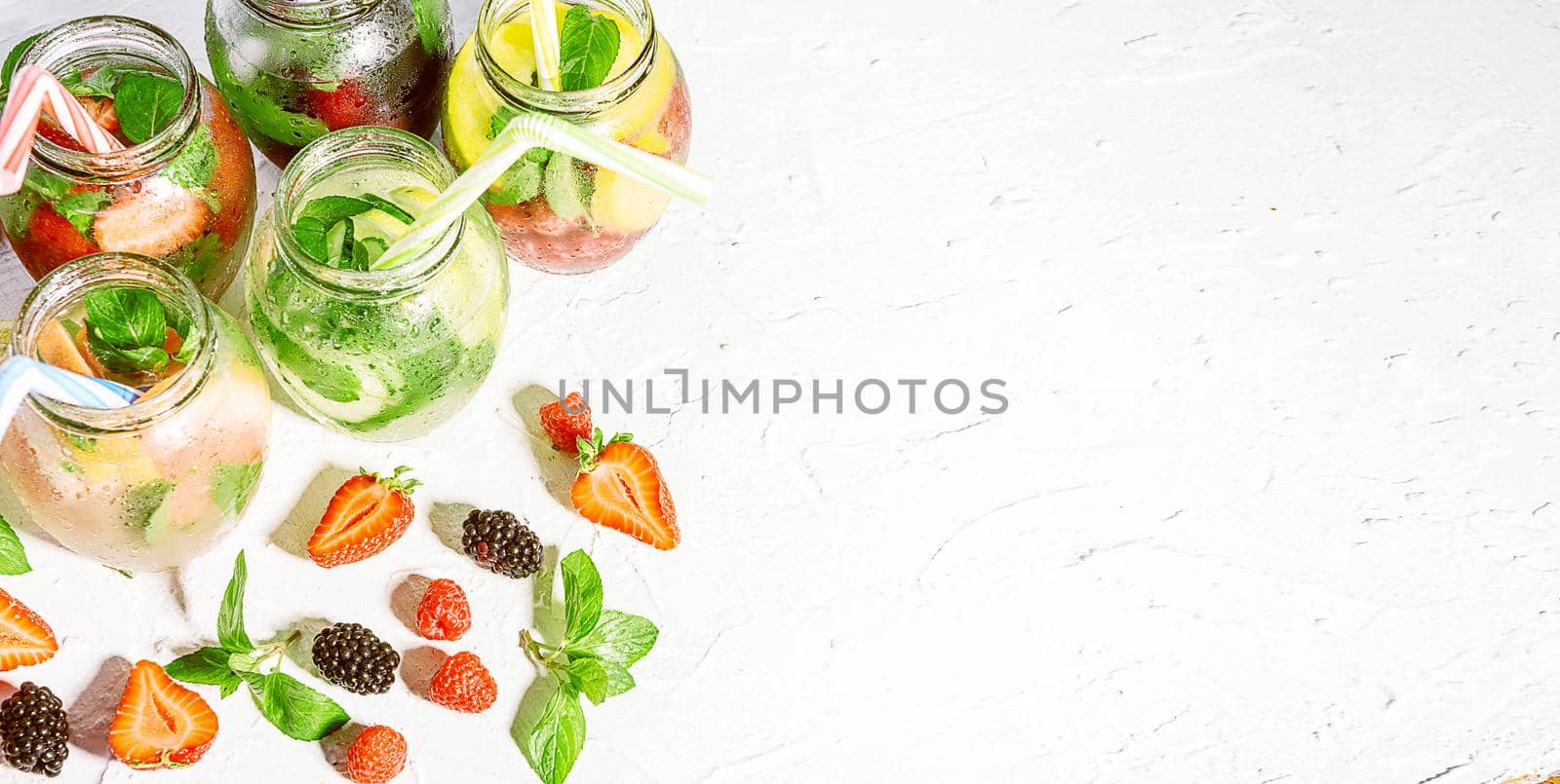 detox smoothies of fresh fruits and vegetables in glass jars with tubes. studio light, light background, space for text