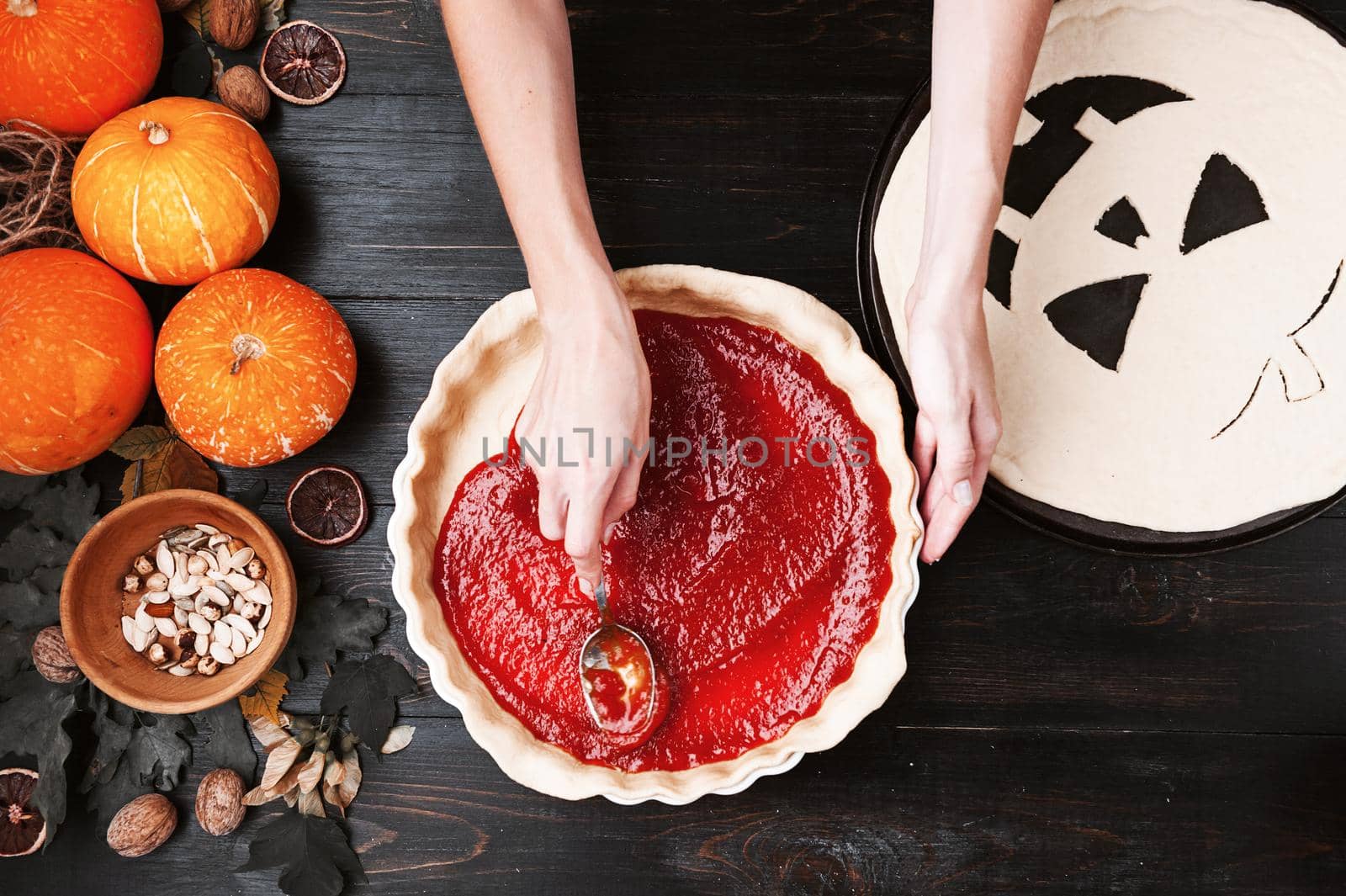 Chef cooks a pie for Halloween with a filling of pumpkin-strawberry jam and peaches