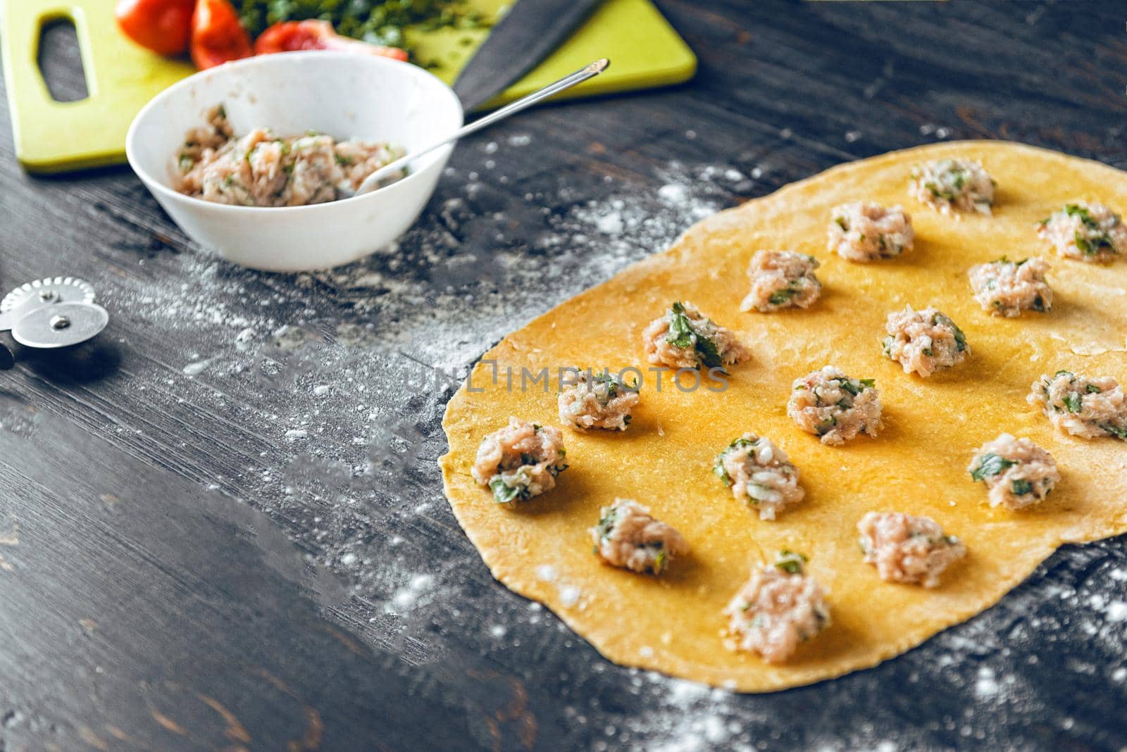 Woman chef cooks step by step the traditional ravioli