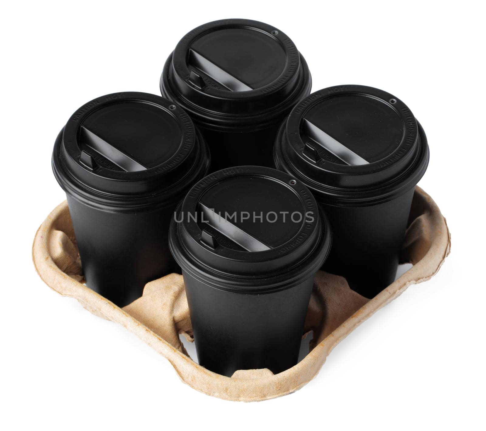 Four takeaway coffee cups in a tray isolated on white background