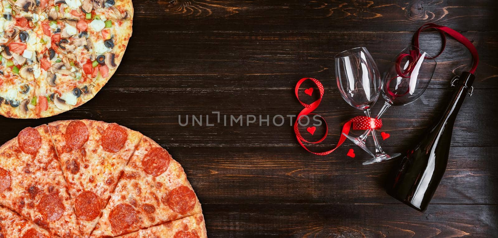 dinner for two in honor of Valentine's Day with pizza and wine.