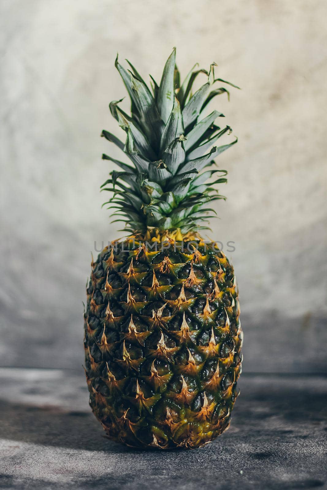 Fresh isolated pineapple on grey background.