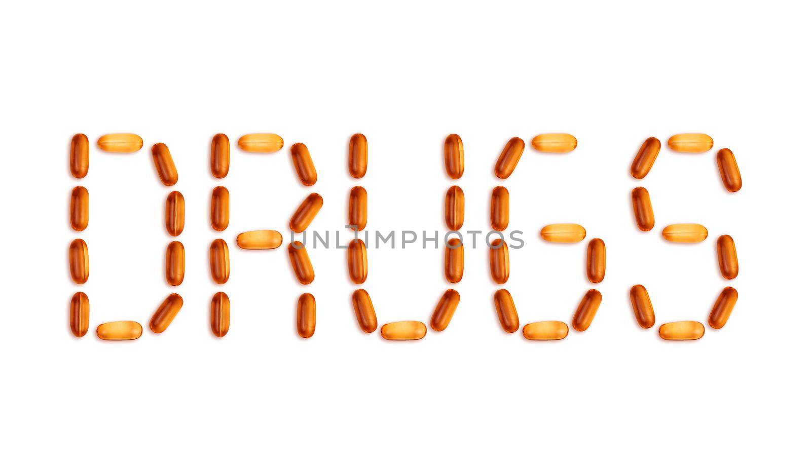 The word Drugs is laid out with pills. The word Drugs is laid out with gel pills on a white background with copy space for text.