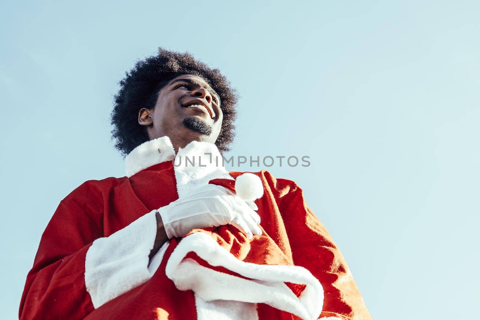 View from below of happy afro santa claus