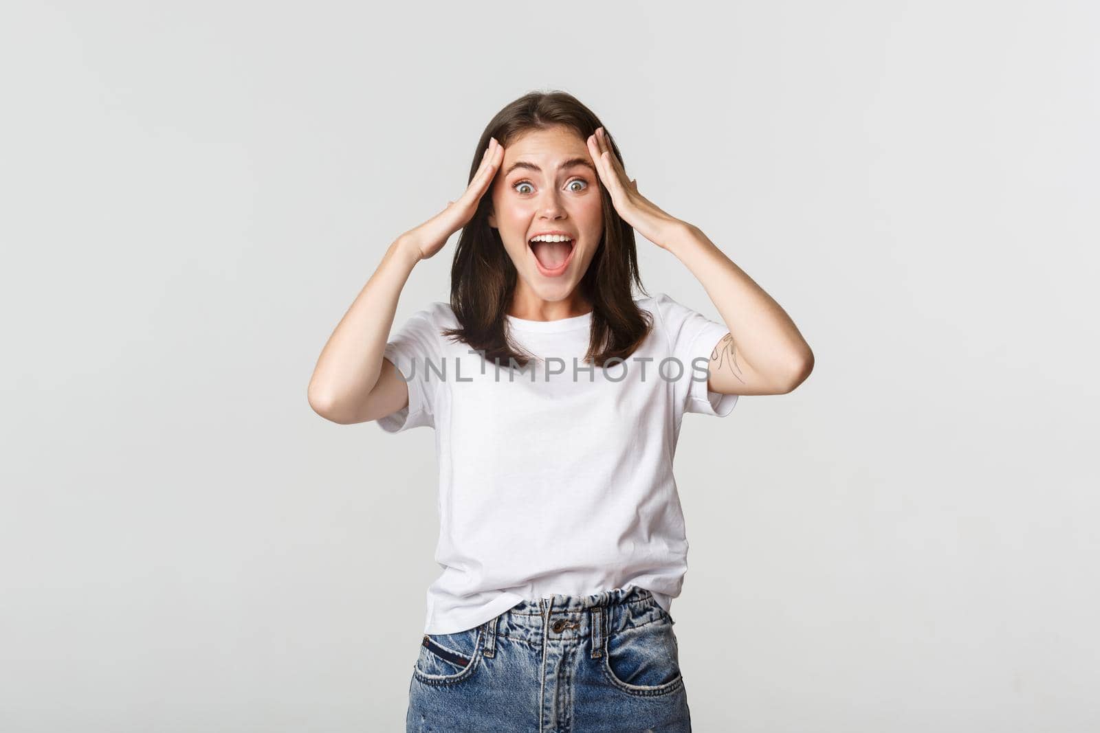 Portrait of surprised attractive girl looking excited and smiling amazed.