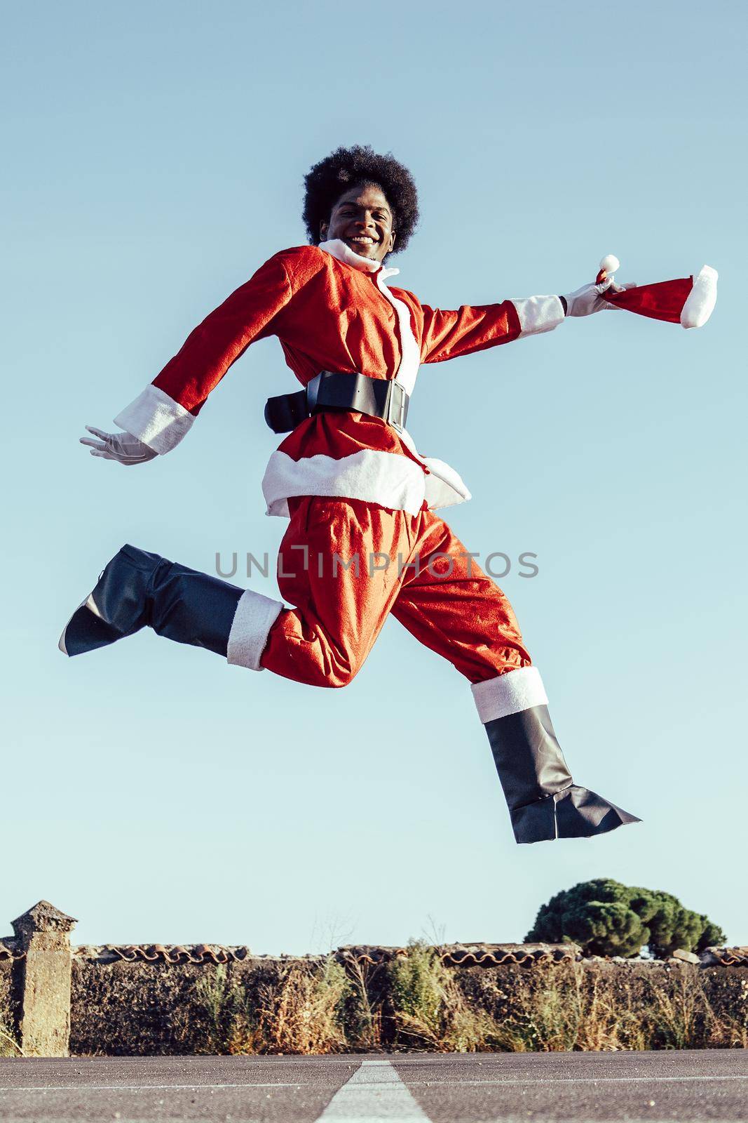 African american santa claus jumping excited and happy